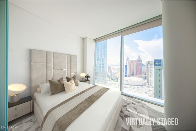 bedroom featuring expansive windows and access to exterior