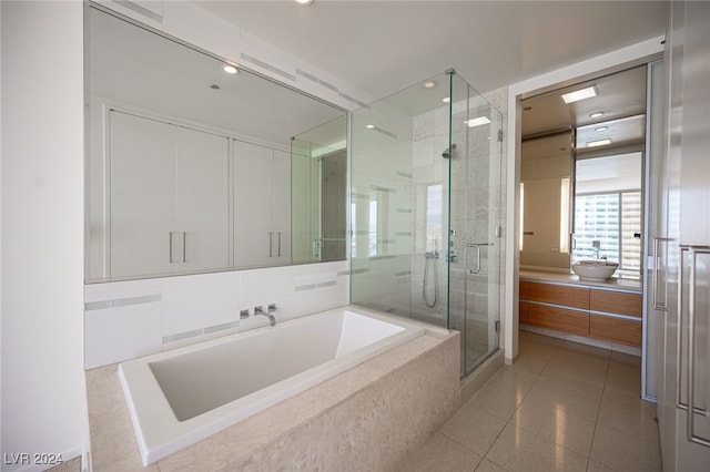 bathroom with independent shower and bath and vanity