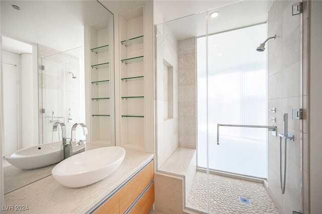 bathroom featuring vanity, tile patterned floors, and a shower with shower door