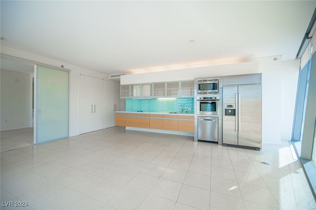 kitchen featuring built in appliances and sink