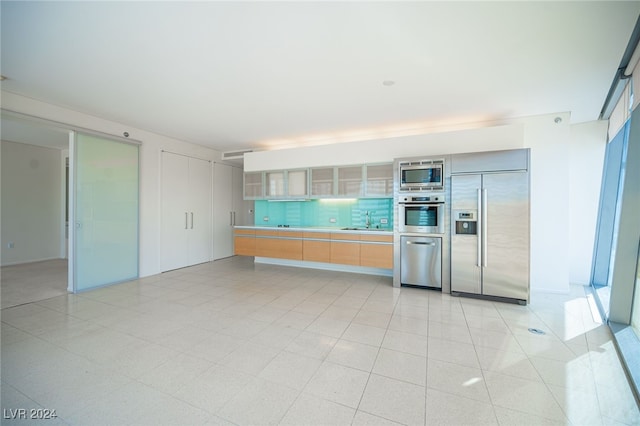 3726 Las Vegas Blvd Unit 2604, Las Vegas, NV 89158 - kitchen featuring built in appliances, glass insert cabinets, and light countertops
