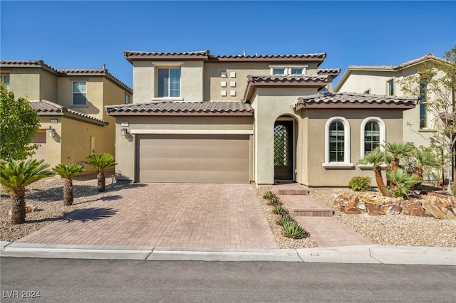 mediterranean / spanish house featuring a garage