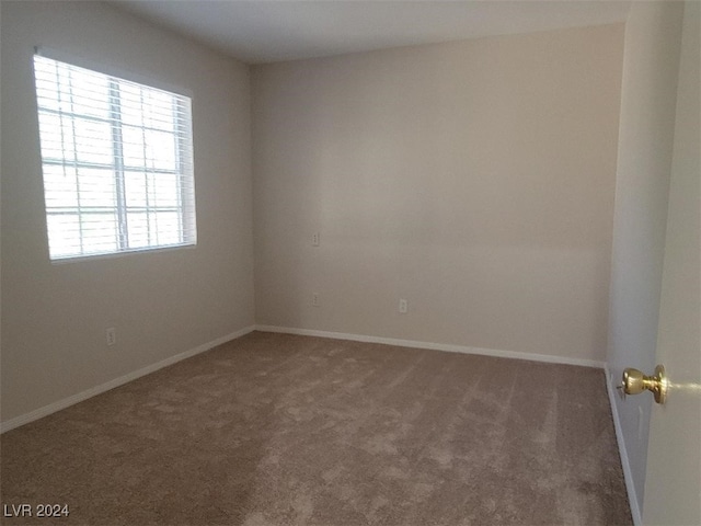 empty room featuring dark carpet