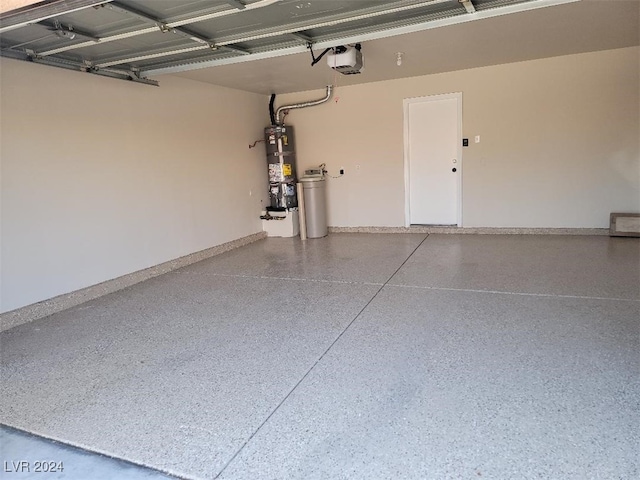 garage featuring water heater, a garage door opener, and baseboards
