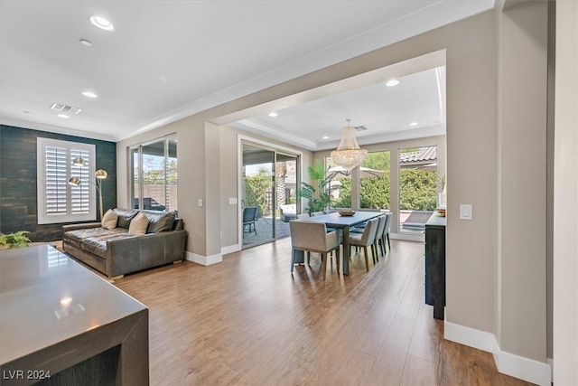 dining area featuring plenty of natural light, hardwood / wood-style floors, and crown molding