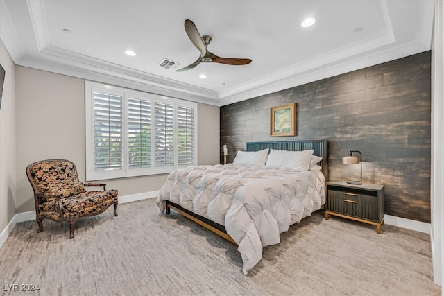 bedroom with ceiling fan and a raised ceiling