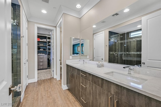 bathroom featuring vanity, hardwood / wood-style flooring, and a shower with shower door