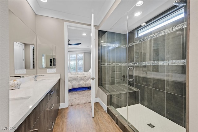 bathroom with a healthy amount of sunlight, vanity, ceiling fan, and hardwood / wood-style flooring