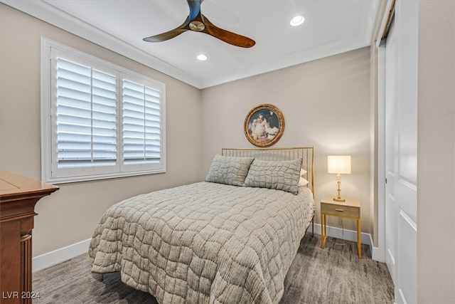 bedroom with ceiling fan, a closet, and dark wood-type flooring