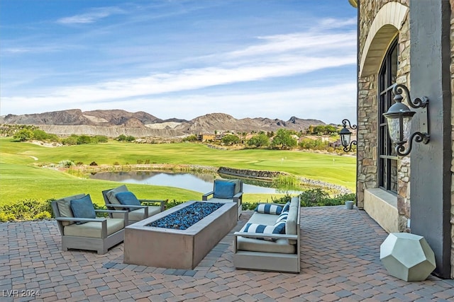 view of patio featuring a water and mountain view