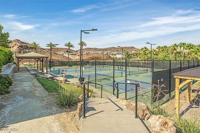 view of sport court with a mountain view and a gazebo