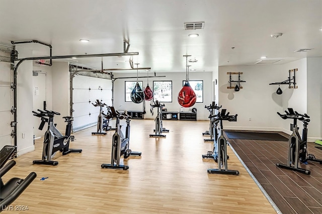 exercise room with light wood-type flooring