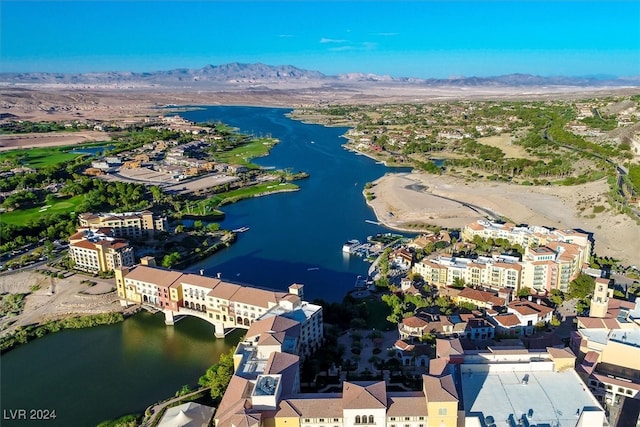 birds eye view of property with a water and mountain view