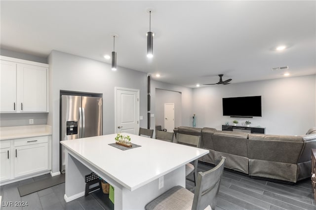 kitchen featuring white cabinetry, ceiling fan, and a kitchen island