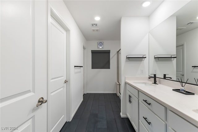 bathroom featuring wood-type flooring, a shower with door, and vanity