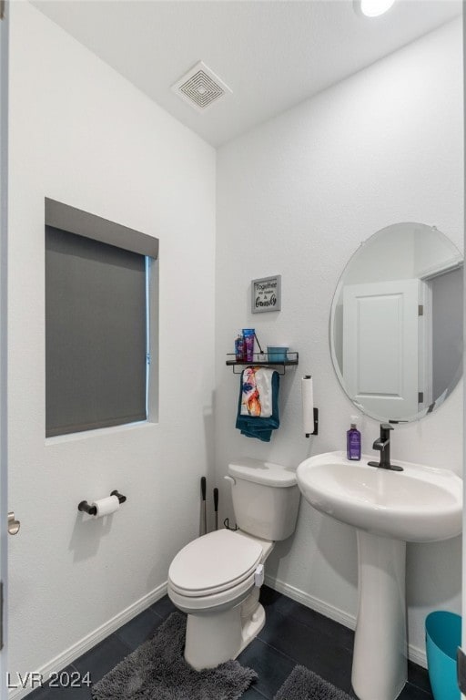 bathroom with tile patterned floors and toilet