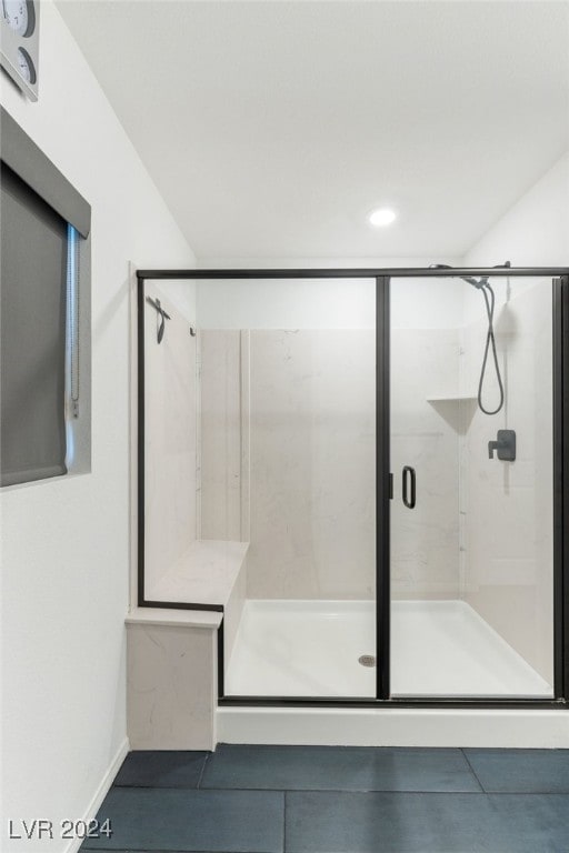 bathroom featuring tile patterned flooring and an enclosed shower