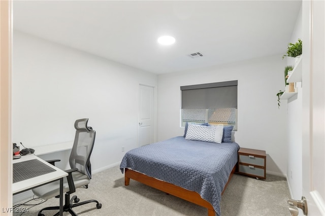 bedroom featuring light colored carpet