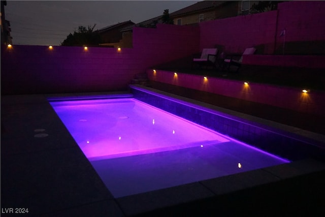 view of pool at night