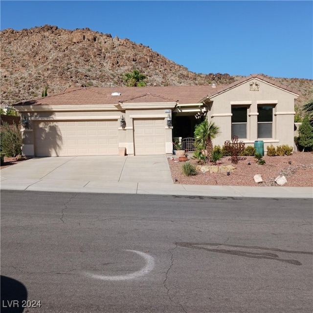 view of front of home featuring a mountain view and a garage