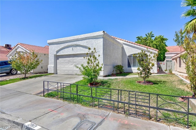 view of front of property featuring a front yard and a garage