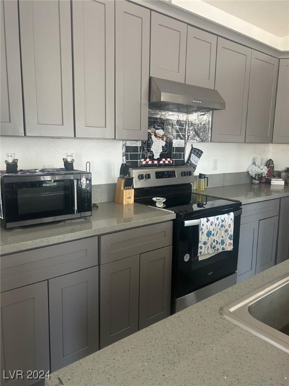 1840 Princeton St, North Las Vegas, NV 89030 - kitchen featuring under cabinet range hood, appliances with stainless steel finishes, and gray cabinets