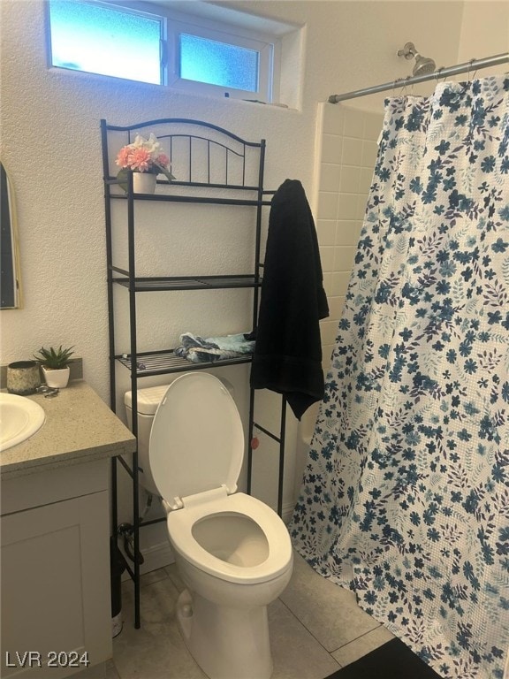1840 Princeton St, North Las Vegas, NV 89030 - full bathroom featuring tile patterned floors, toilet, a shower with curtain, vanity, and healthy amount of natural light