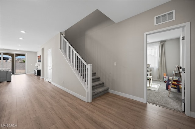 staircase with hardwood / wood-style floors