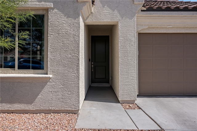 doorway to property featuring a garage