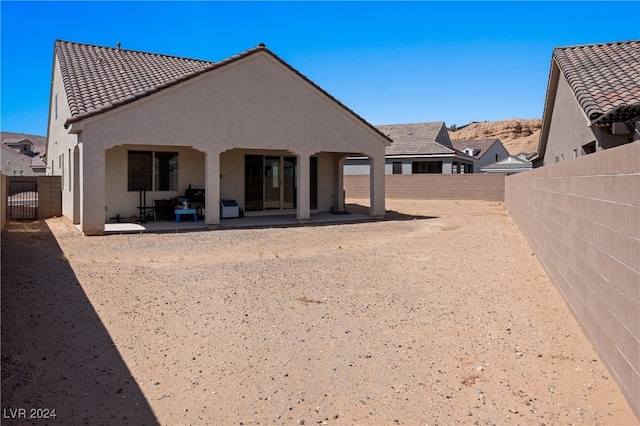 rear view of property featuring a patio area