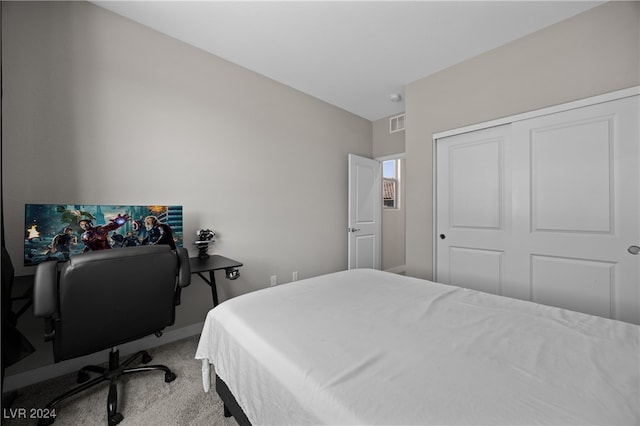 carpeted bedroom featuring a closet