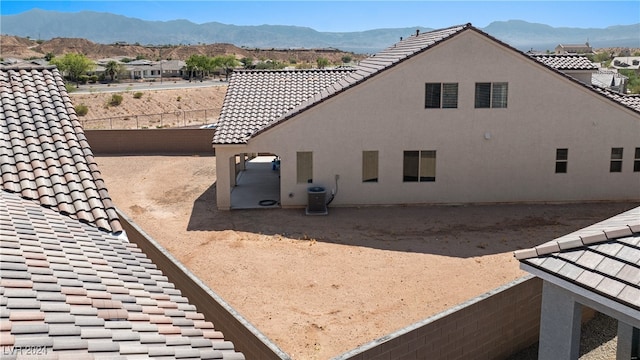 view of side of home with cooling unit and a mountain view