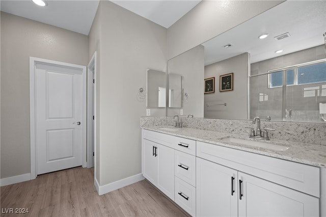 bathroom featuring vanity, a shower with shower door, and hardwood / wood-style flooring