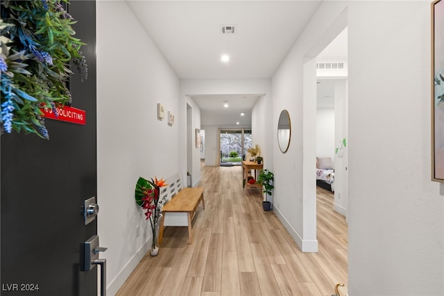 hallway with light hardwood / wood-style flooring