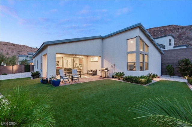 rear view of house featuring a yard and a patio