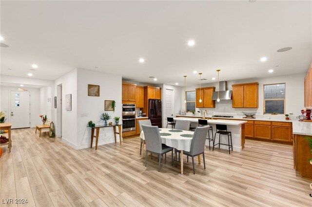 dining area with light hardwood / wood-style floors