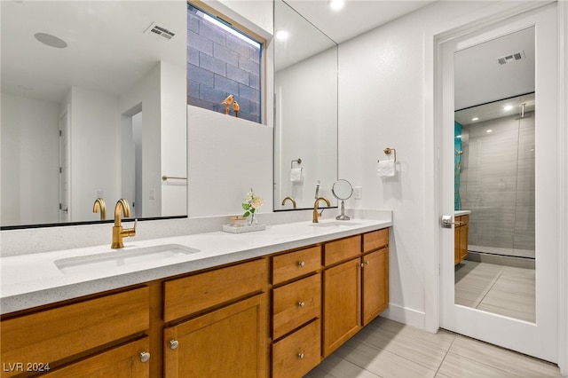 bathroom with vanity, an enclosed shower, and tile patterned floors