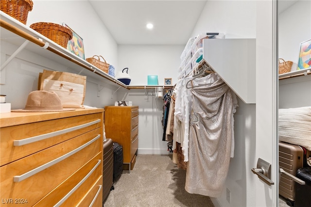 spacious closet featuring light colored carpet