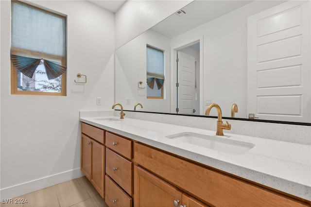 bathroom featuring tile patterned flooring and vanity