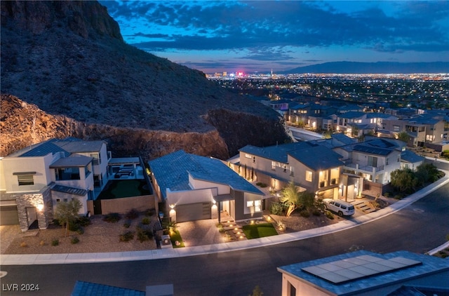 aerial view at dusk featuring a mountain view