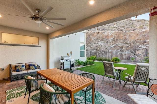 view of patio featuring ceiling fan and a grill