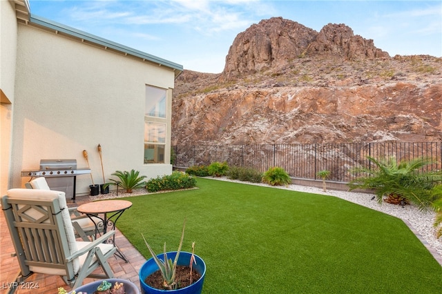 view of yard with a patio and a mountain view