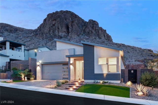 modern home featuring a mountain view and a garage