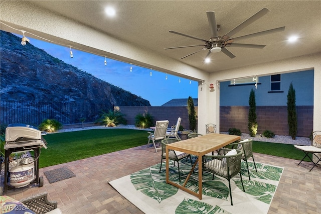 view of patio featuring area for grilling and ceiling fan