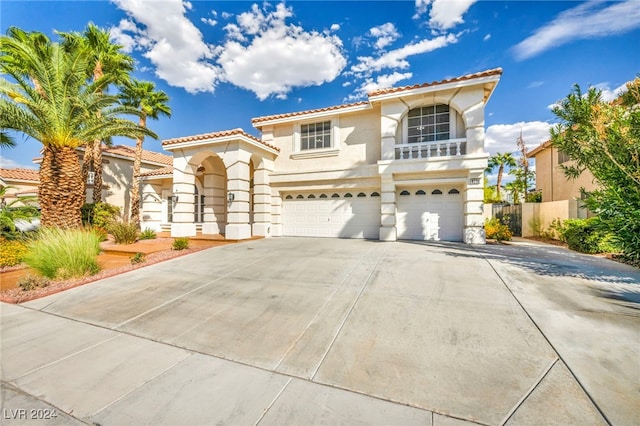 mediterranean / spanish-style house with a garage