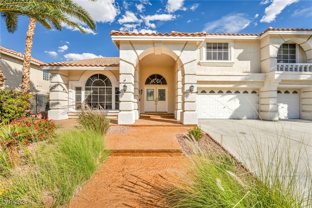 mediterranean / spanish house with a garage