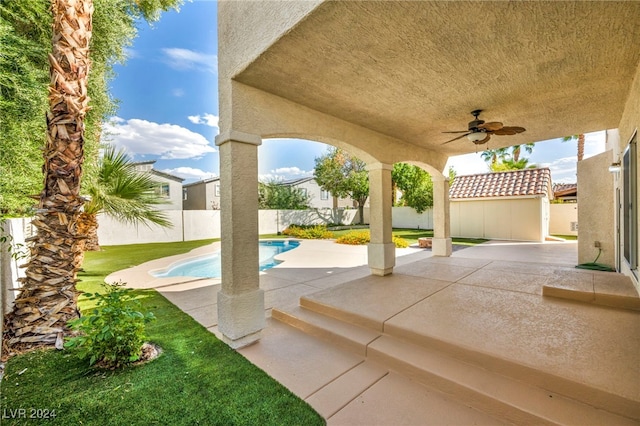 view of patio / terrace with a fenced in pool and ceiling fan