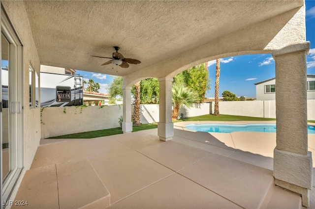 view of patio / terrace with a fenced in pool and ceiling fan