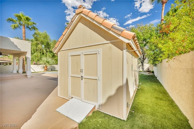 view of outbuilding with a lawn