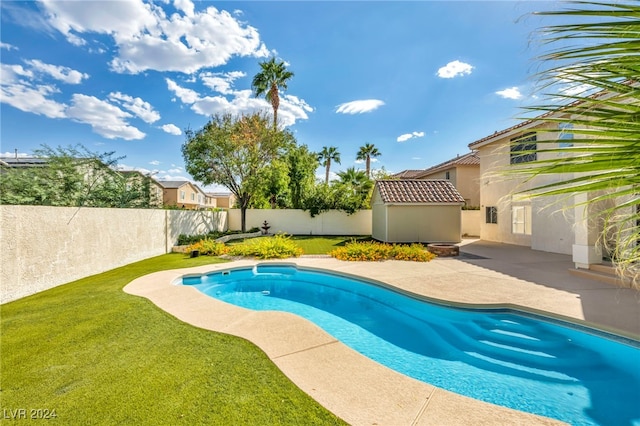 view of pool with a lawn and a patio area